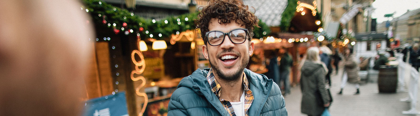 Guy in streets at a market.