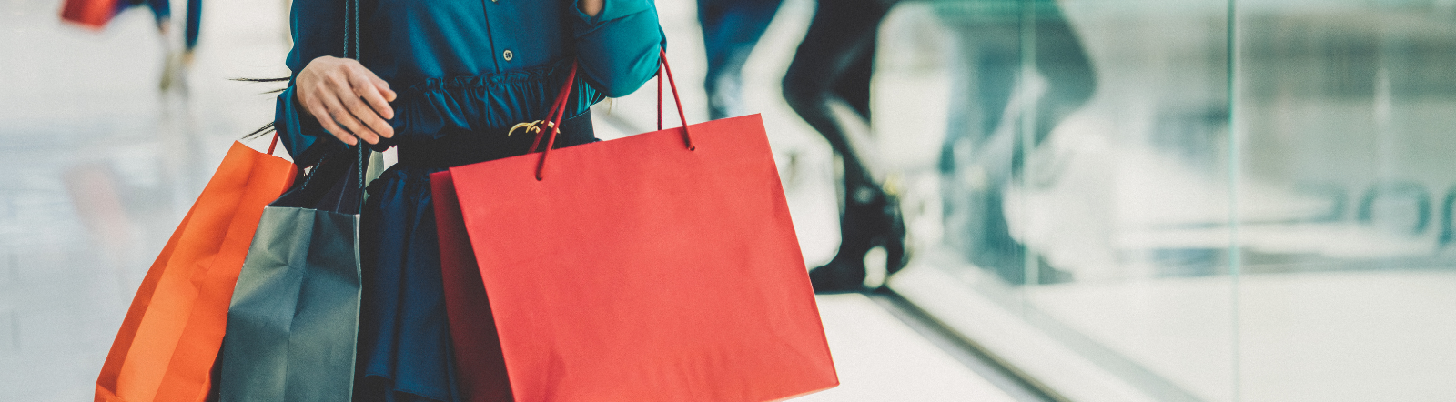 woman holding several shopping bags