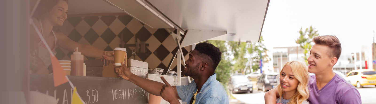 female hands customer a cup from her food truck