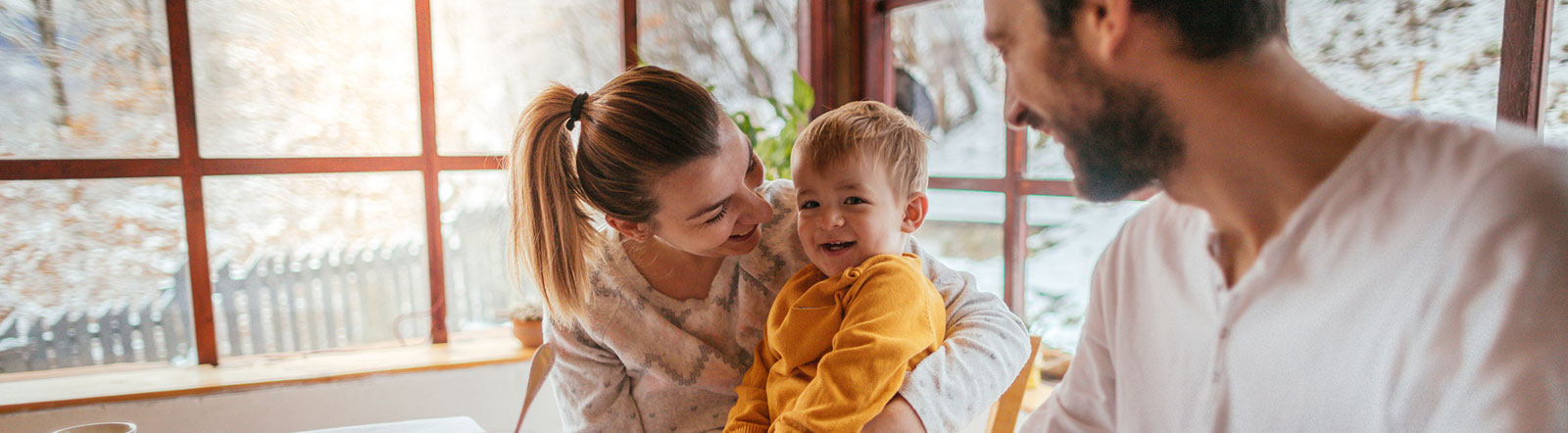 Parents and young child at home.