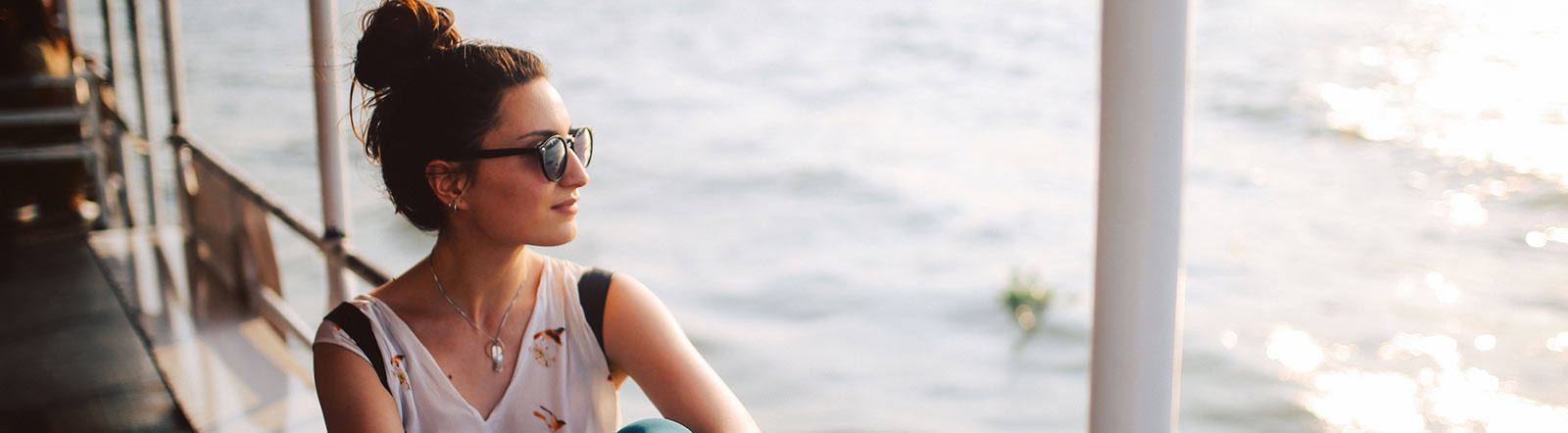 Relaxed woman gazing off into the water.