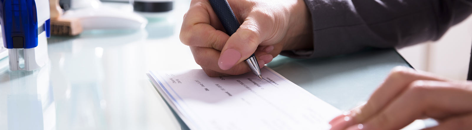 Woman writing business check.