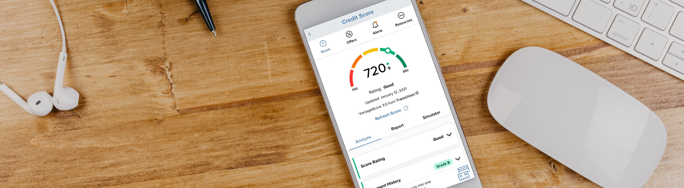 smartphone on wood grain desktop showing credit score