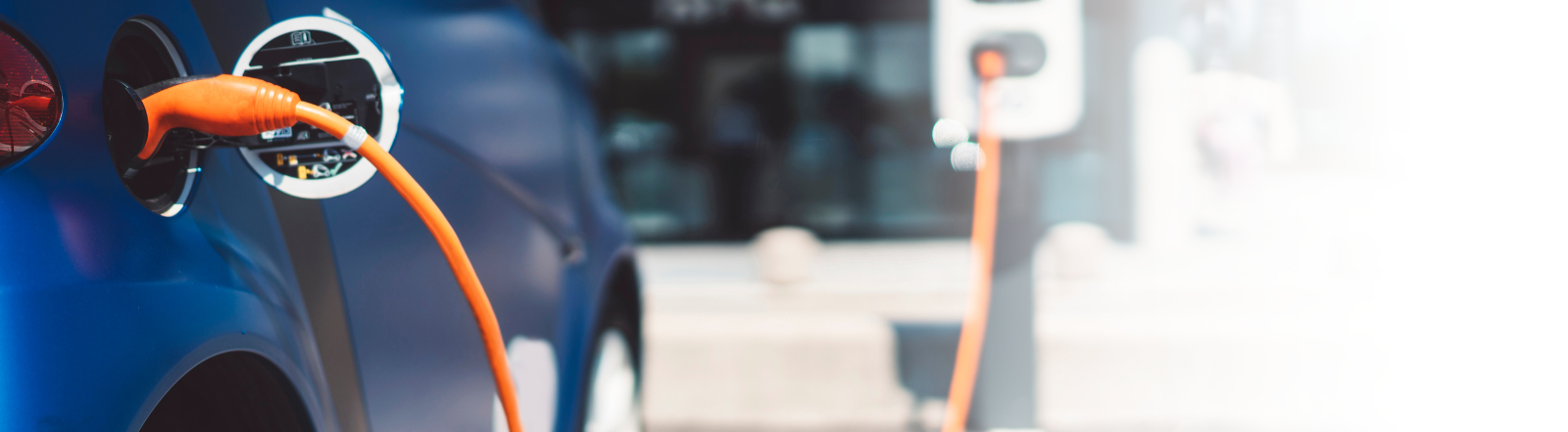 small electric car connected to a charging station