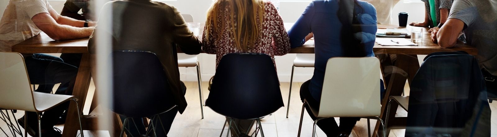 team of workers around a modern conference table