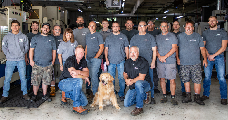 18 employees of ITD Engineering in Richmond, Indiana smile for a group picture