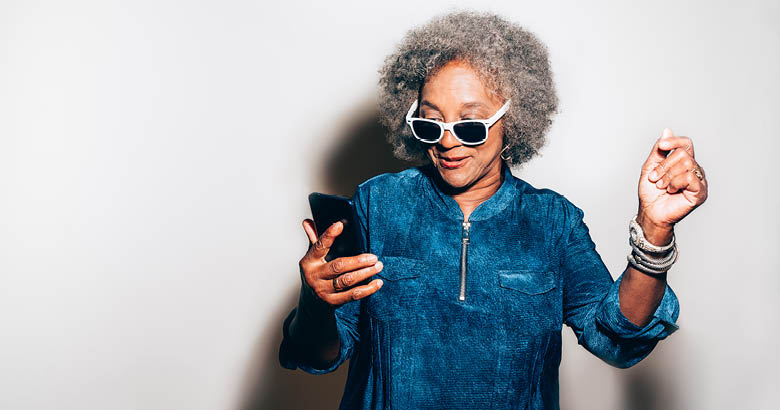 woman wearing sunglasses looking at phone