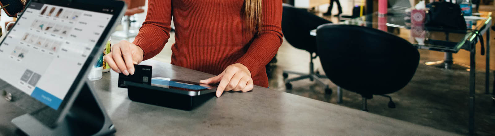 woman swiping her credit card at a pay station