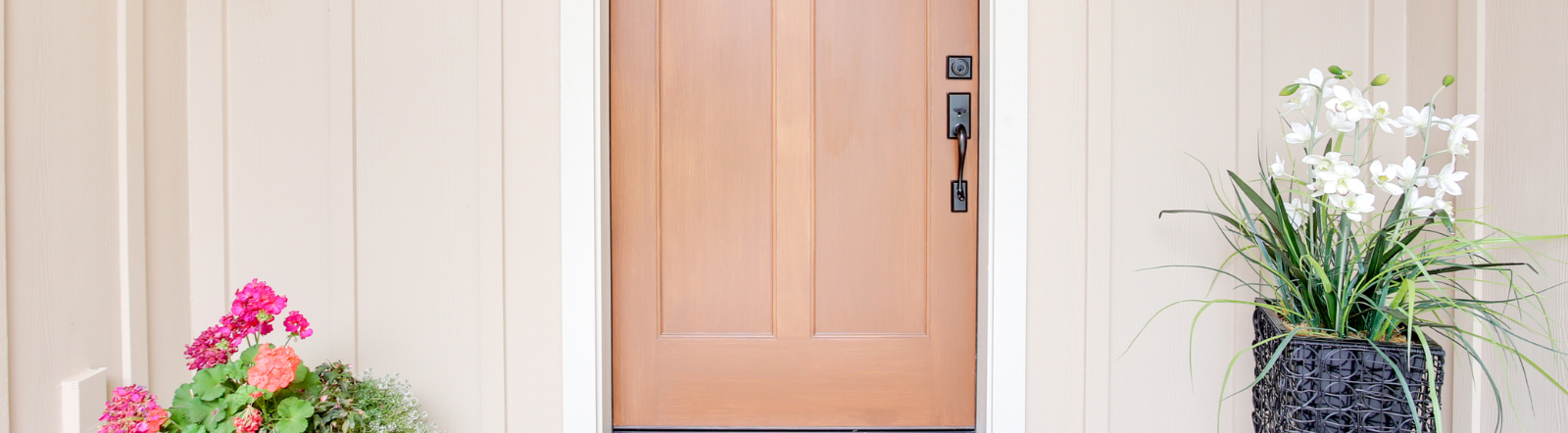 front door surrounded by flowers