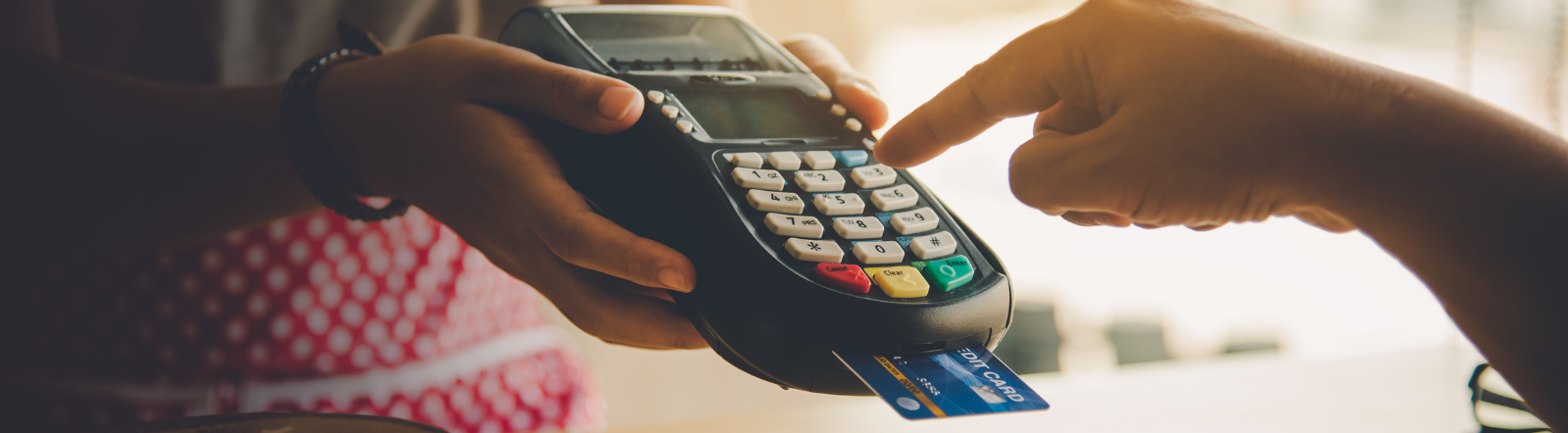 hand operates a point of sale card reader