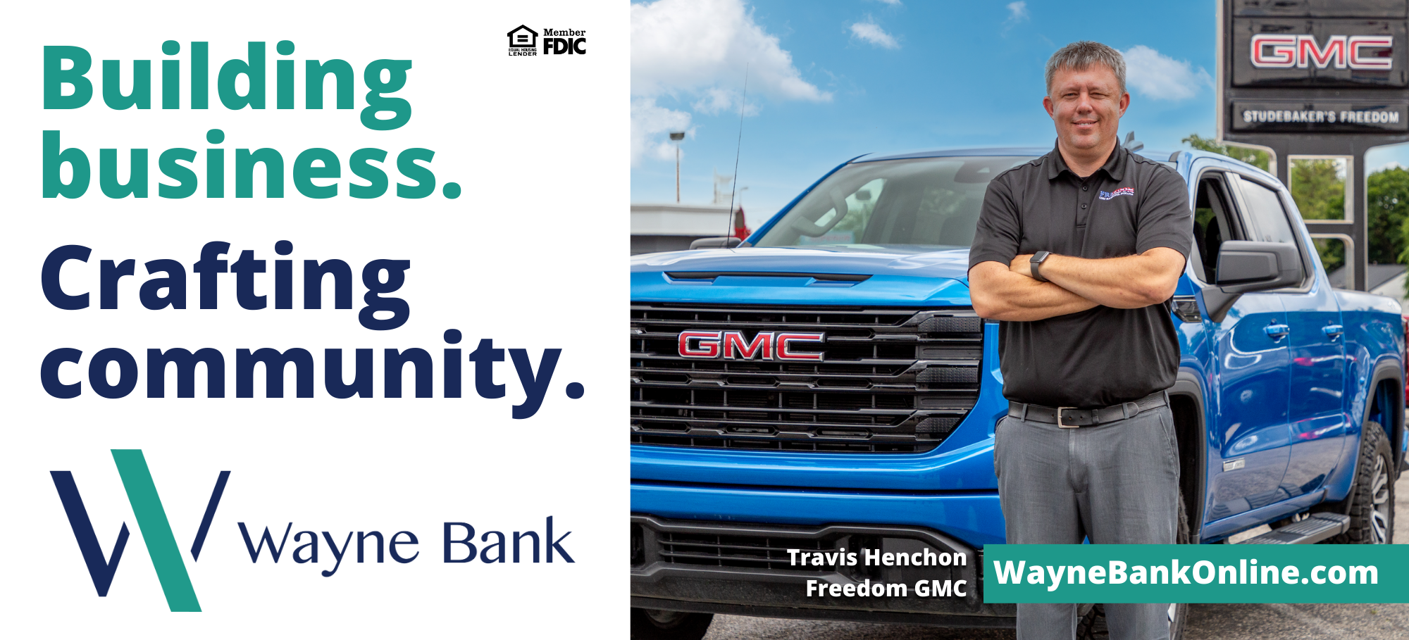man smiles in front of pickup truck
